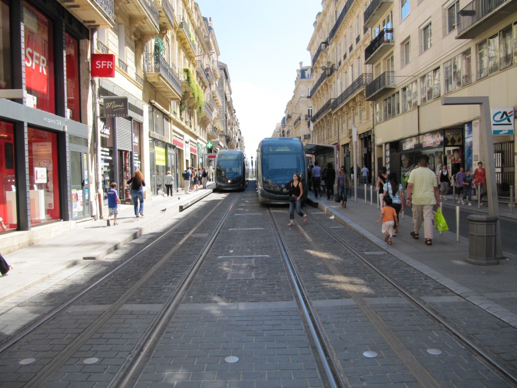 Two wireless trams serve paired center city station platforms